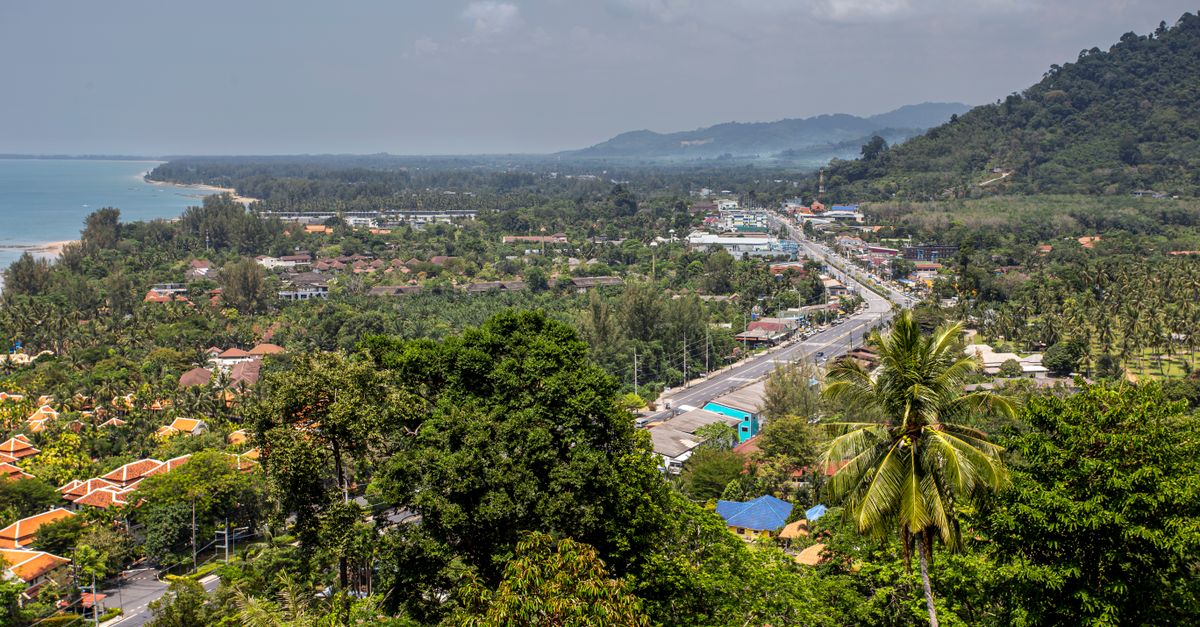 Discover the lush beauty of Phang-nga, Thailand, with its tropical beach, mountains, and vibrant town.