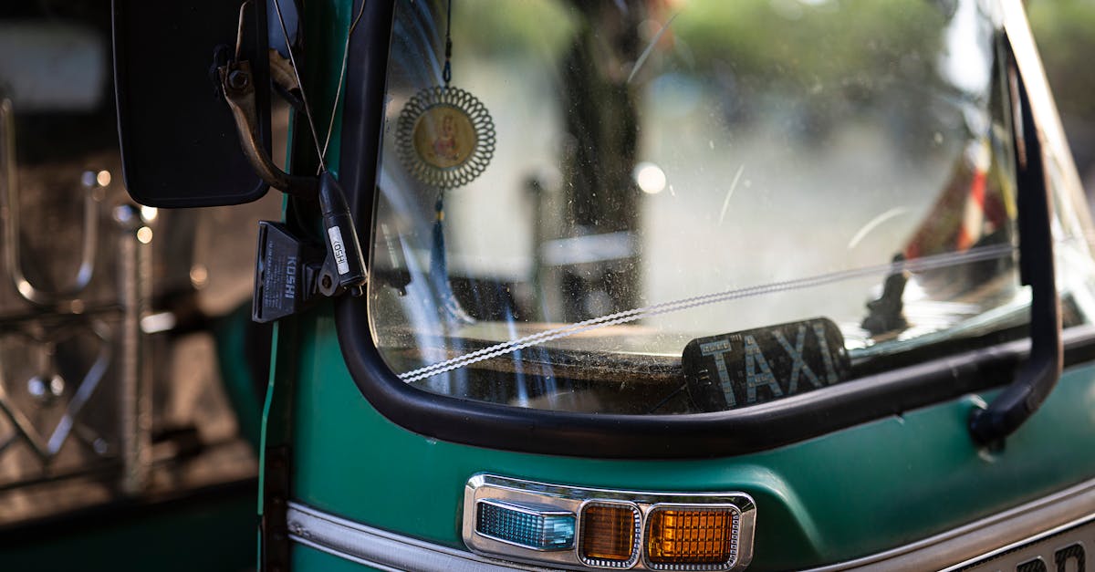 Green tuk-tuk taxi close-up showing windshield and details in Colombo, Sri Lanka.