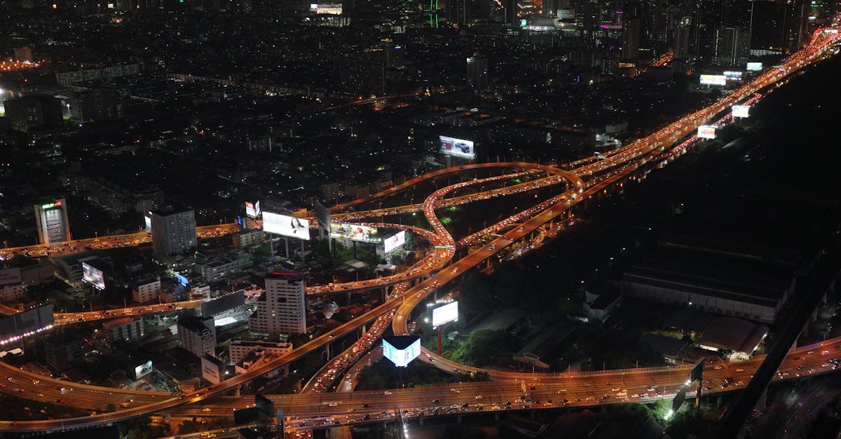 A stunning aerial view of Bangkok's illuminated expressways at night.