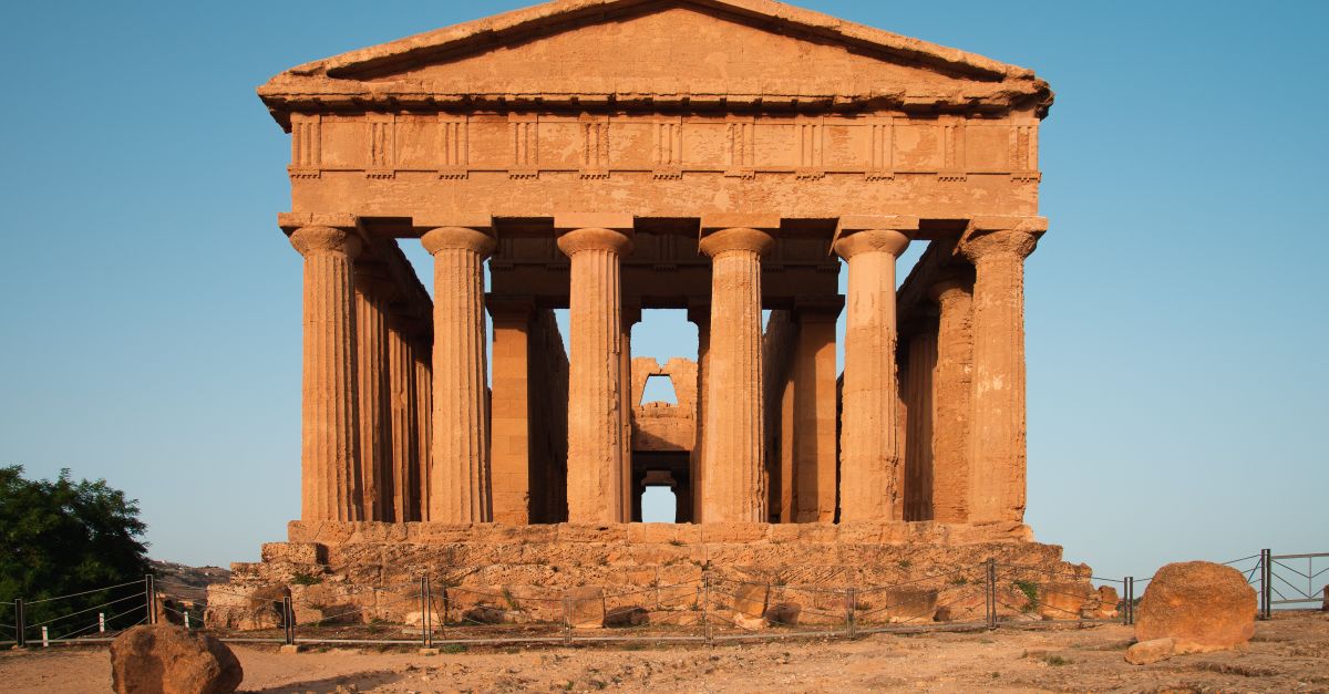 View of the ancient Temple of Concordia in Agrigento, Sicily, during sunset.