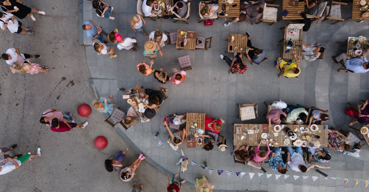 Top-down drone shot of people dining outdoors at a cafe in Novosibirsk, capturing summer vibes.