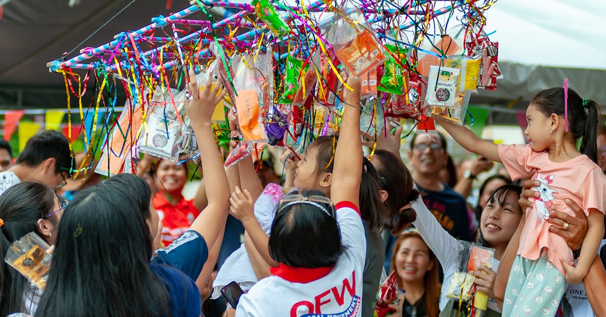 Joyful gathering of people enjoying the traditional Pabitin game at an outdoor festival.