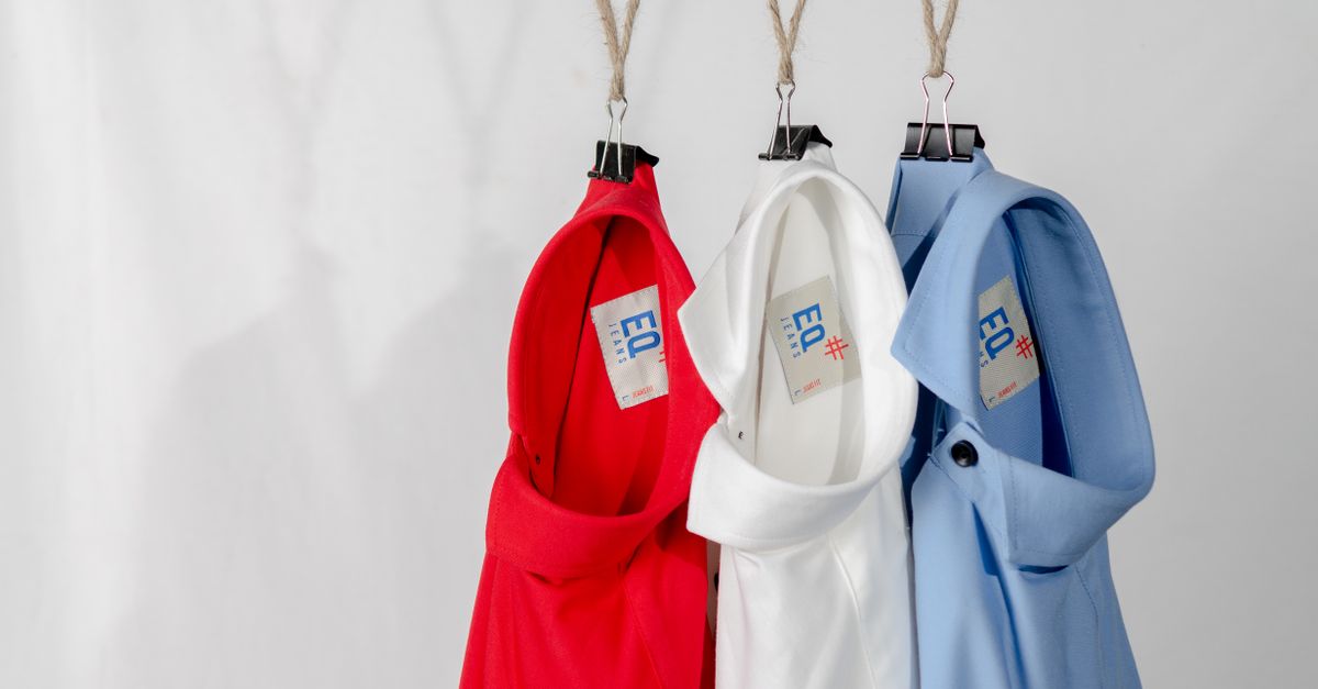 Fashionable red, white, and blue shirts hanging neatly on a white background.