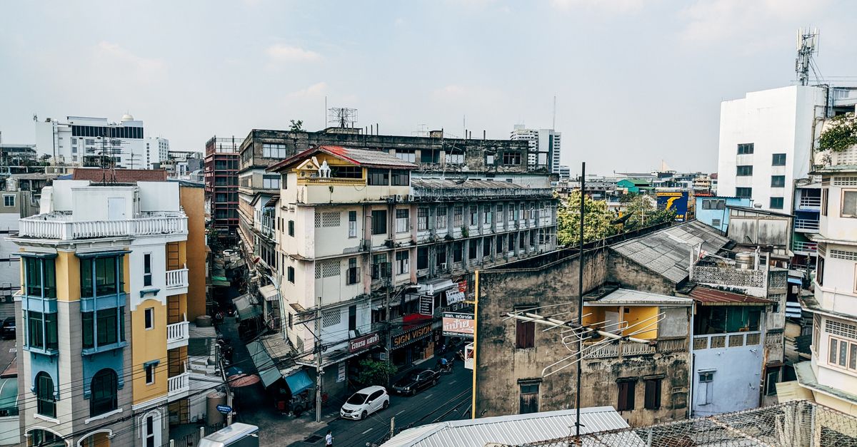 Aerial view of urban residential district showcasing diverse architecture and bustling city streets.