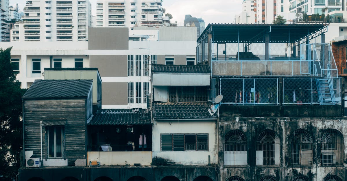 A juxtaposition of aging and modern urban buildings in a dense city landscape.