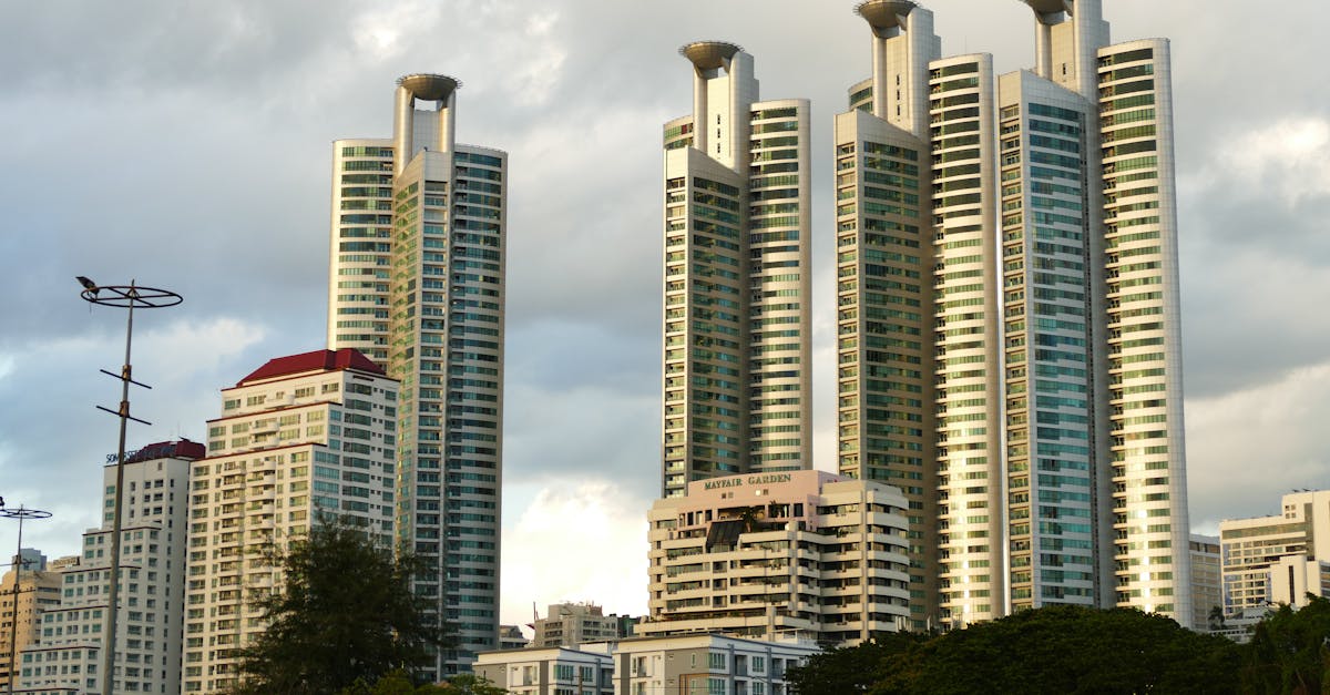 A low angle view of modern high-rise residential towers against a cloudy sky.