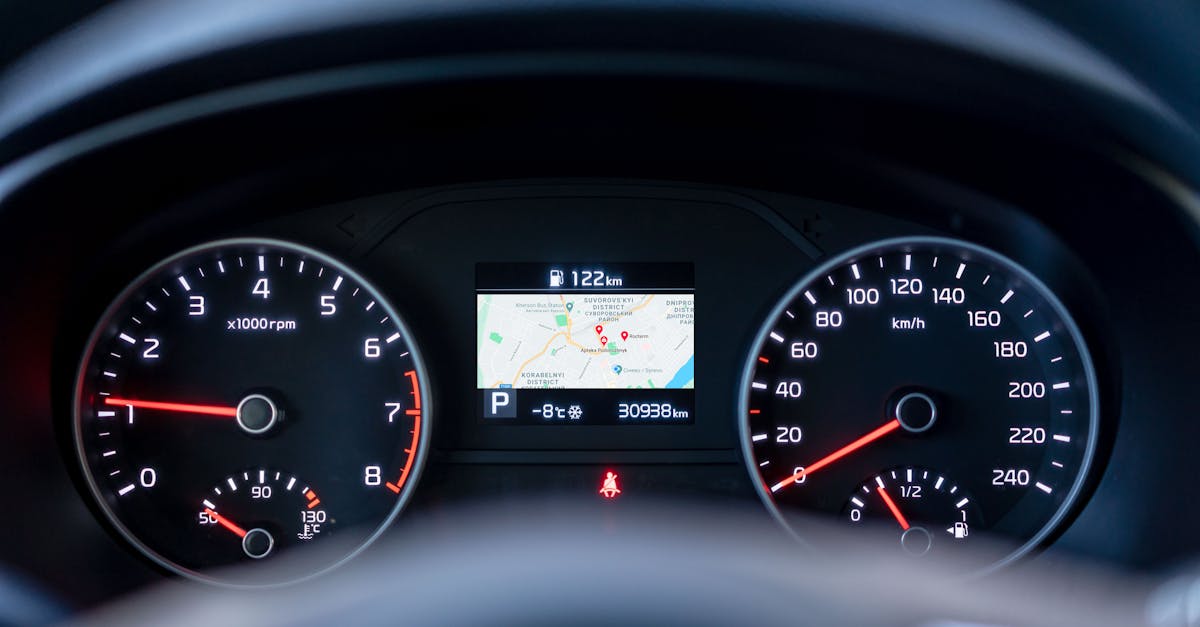 Close-up of a car dashboard showing speedometer, tachometer, and GPS display.