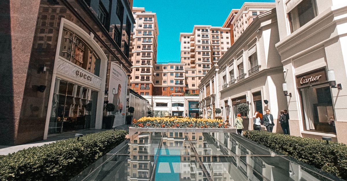 Explore luxury storefronts in a modern Istanbul shopping center with vibrant reflections.
