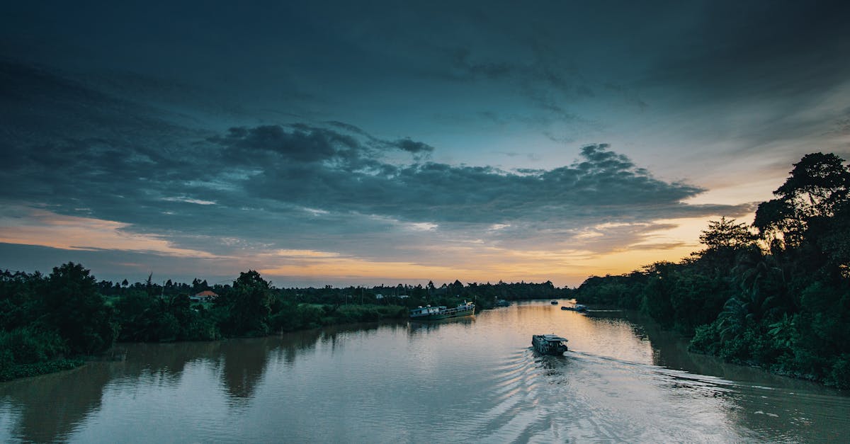 Tranquil river landscape with a boat during a beautiful dusk setting. Calm and serene scenery.