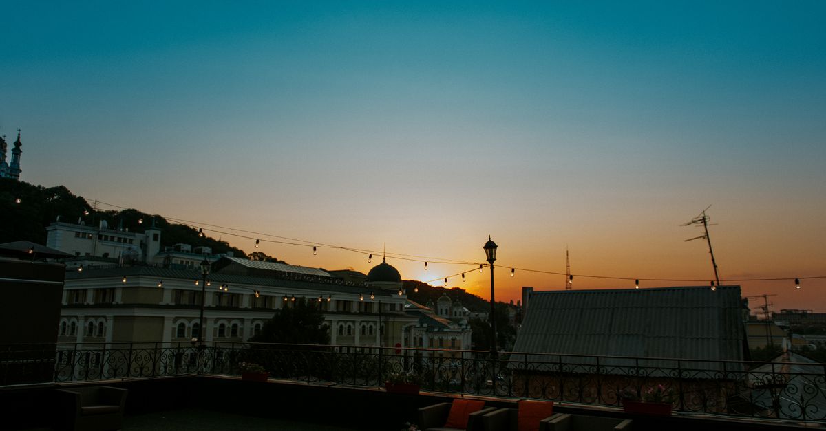 Charming city rooftop lounge view at sunset, perfect ambiance for relaxation.