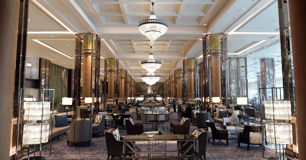 Spacious and elegant hotel lobby with luxurious seating and grand chandeliers, offering a sense of opulence and relaxation.