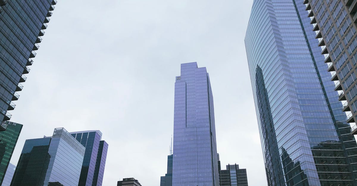 Low angle view of modern skyscrapers in Chicago's cityscape on a cloudy day.