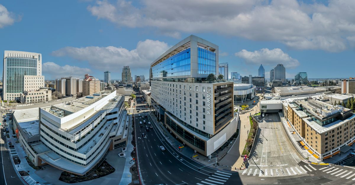 Panoramic aerial view of Sacramento's cityscape, capturing modern skyscrapers and urban architecture.