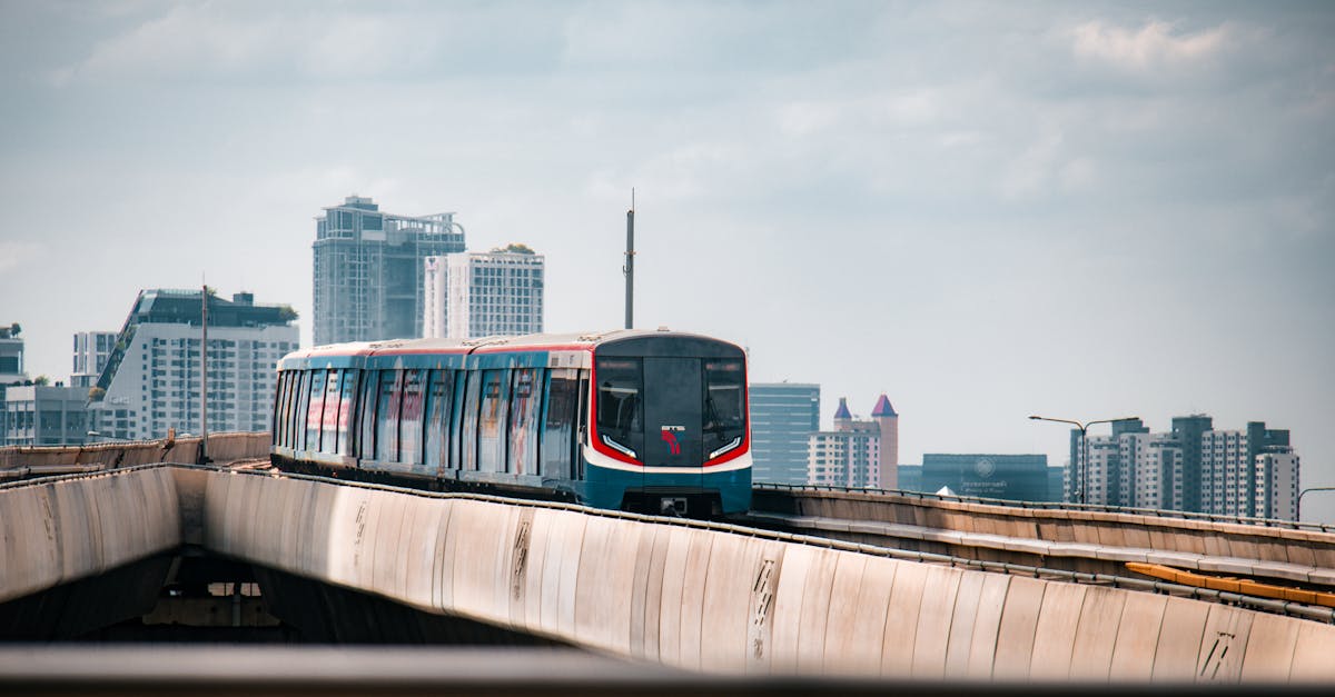 BTS Skytrain traversing urban Bangkok with skyscrapers in the background.