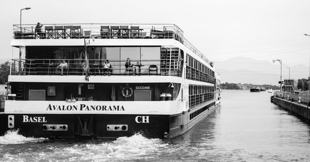 A tourboat navigating the Rhine River, showcasing river tourism in a monochrome setting.