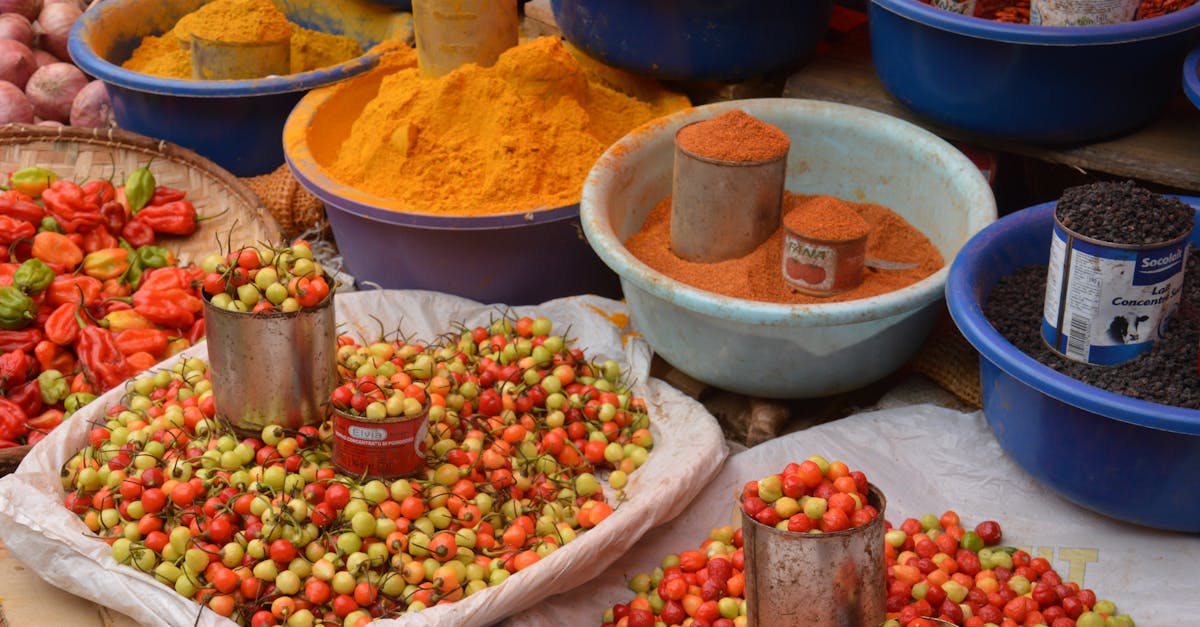 Colorful spices and fresh produce beautifully arranged at an outdoor market.