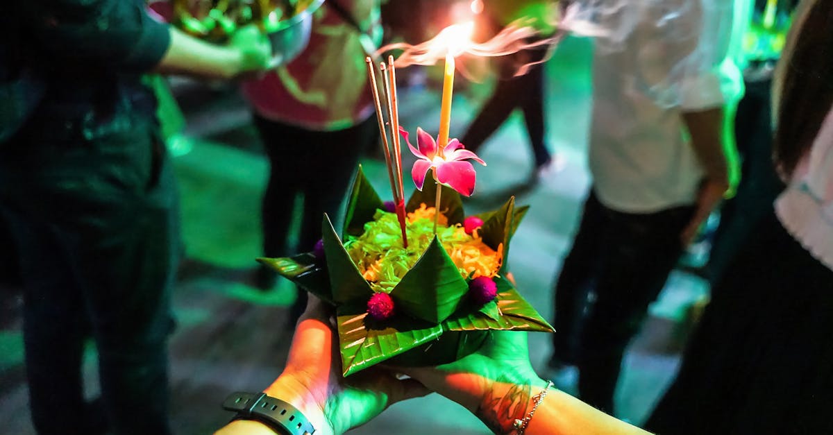 Capturing the vibrant tradition of Loy Krathong with a floating offering adorned with a candle and flowers.