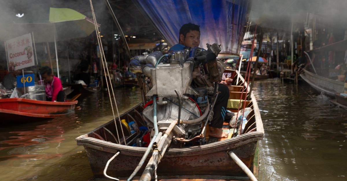 Experience the bustling energy of a Bangkok floating market with vibrant boats and local life.