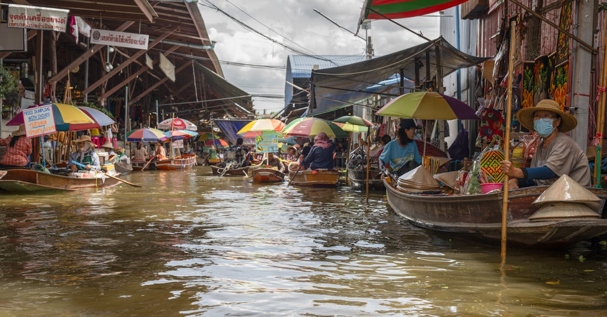 Explore the bustling floating market in Bangkok with colorful boats and lively atmosphere.