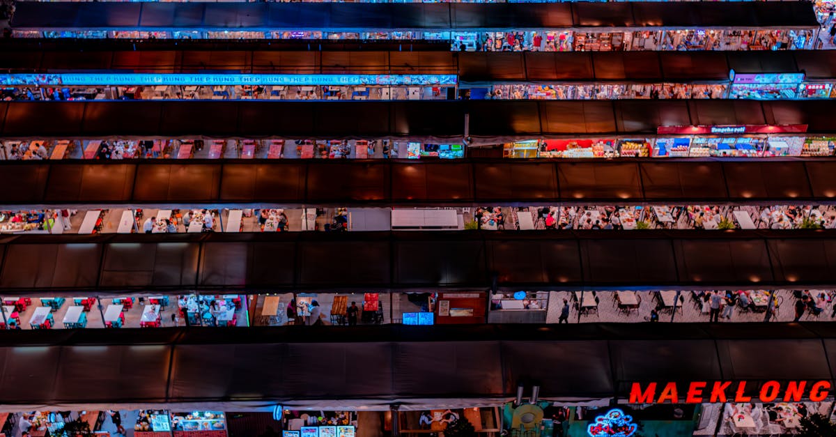 Experience the bustling energy of Bangkok's iconic Maeklong night market with vibrant stalls.