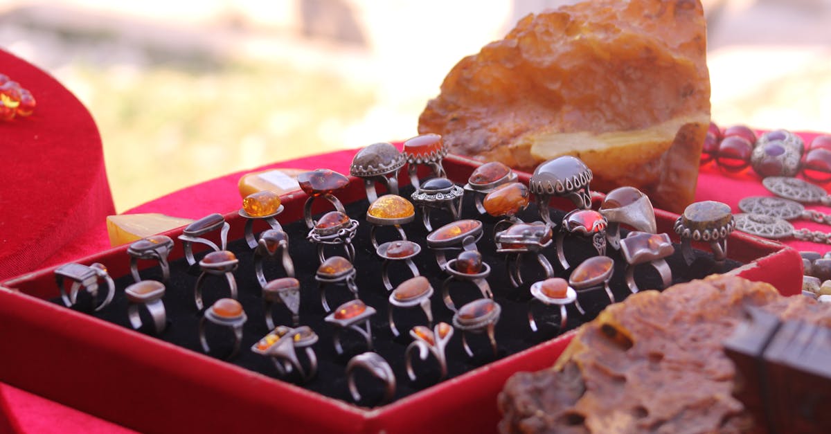 Elegant collection of amber rings on red velvet, perfect for jewelry enthusiasts.