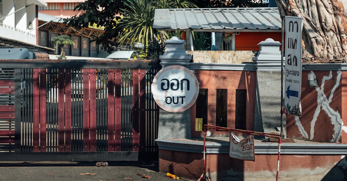 Street scene in Chiang Mai, Thailand featuring an 'Out' sign in Thai and English.