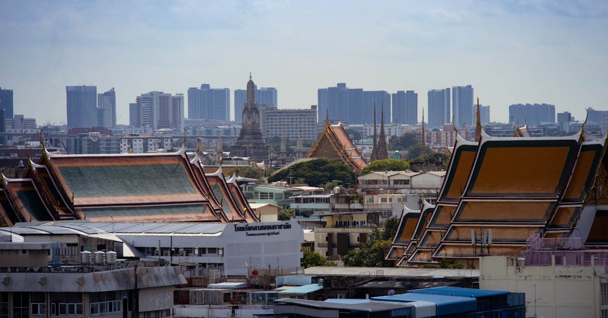 Skyline view of Bangkok highlighting traditional Thai architecture amidst modern buildings.