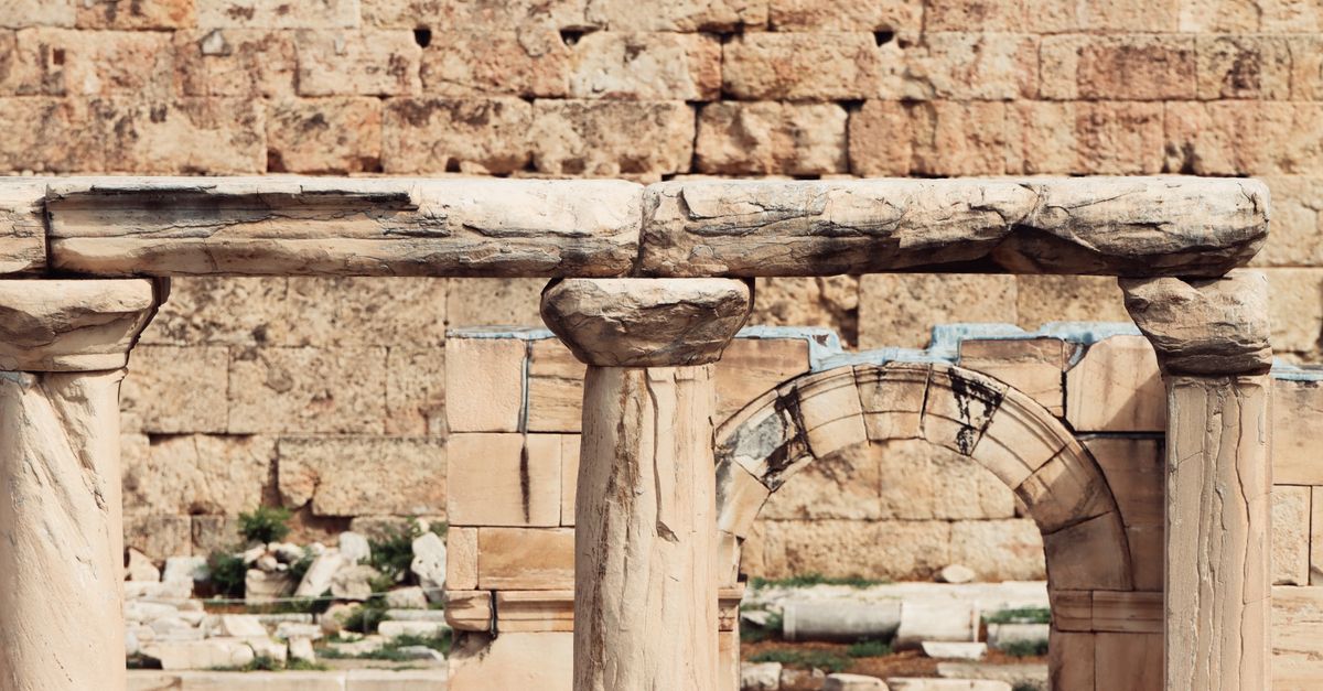 Detailed view of ancient stone columns and arches in Athens, showcasing Greek architecture.