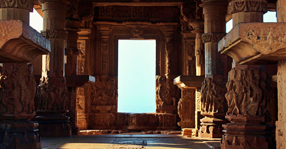 Explore the detailed carvings and stone pillars inside a historic temple.