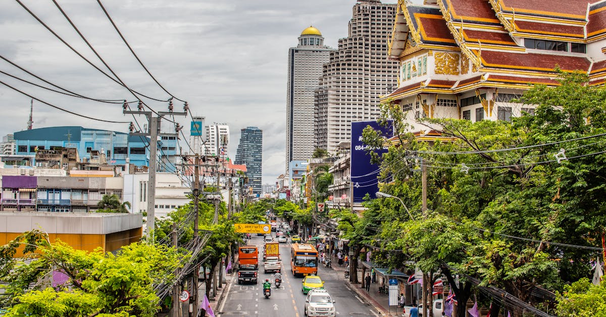Bustling Bangkok street with traffic and iconic architecture. Urban life in Thailand's capital.