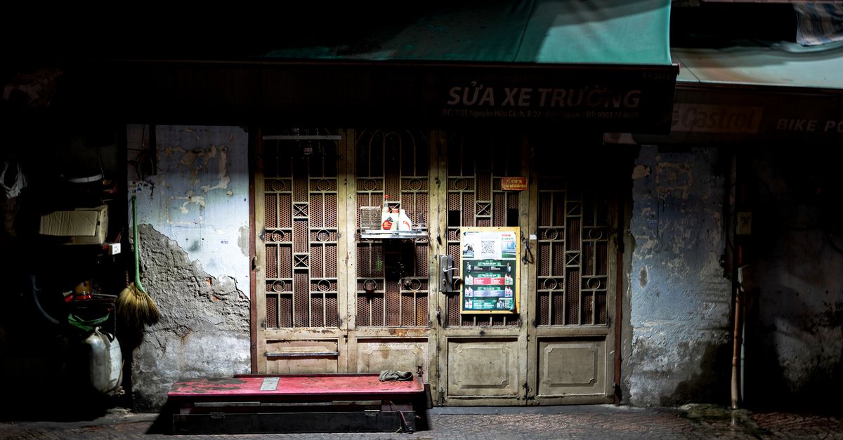 Explore a charming nighttime view of a rustic Vietnamese shop in Ho Chi Minh City.