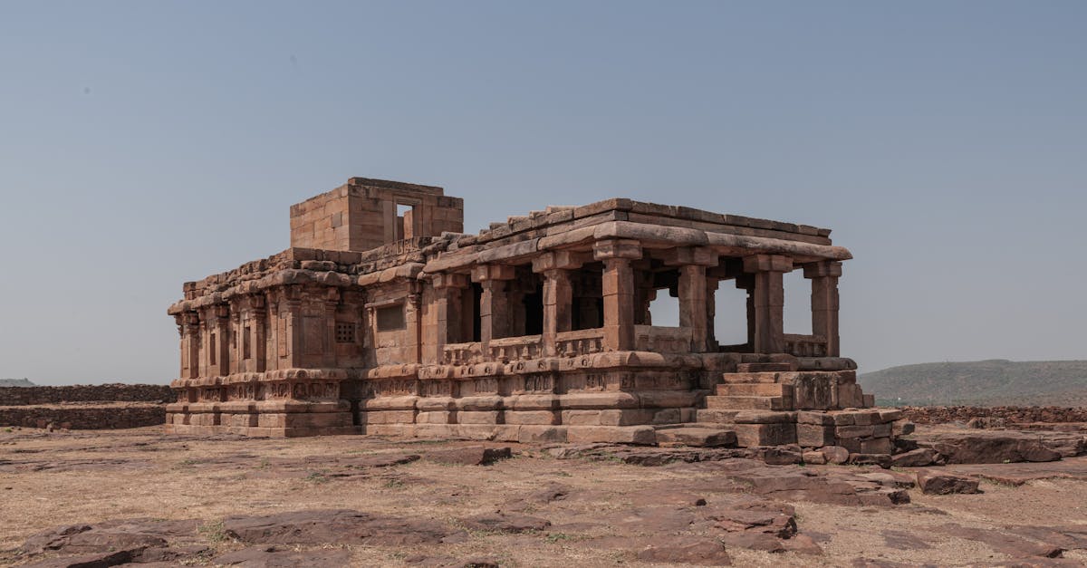 Explore the ancient temple ruins in Aihole, Karnataka, showcasing historic architecture under a clear sky.