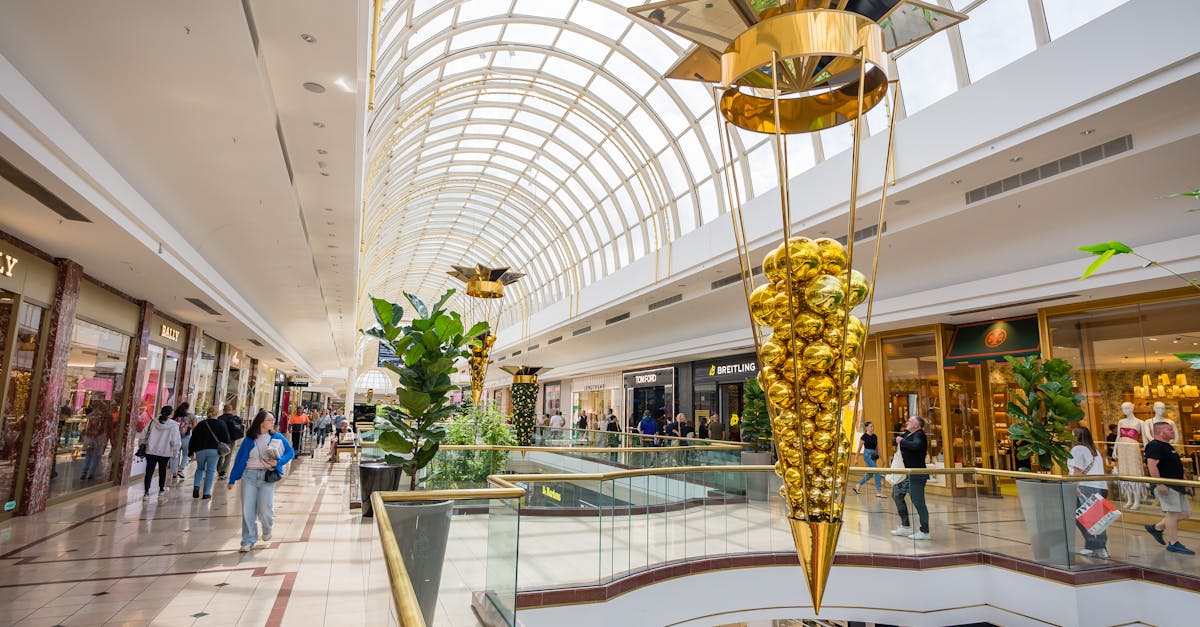 Vibrant shopping mall interior featuring holiday decorations and shoppers enjoying the seasonal ambiance.