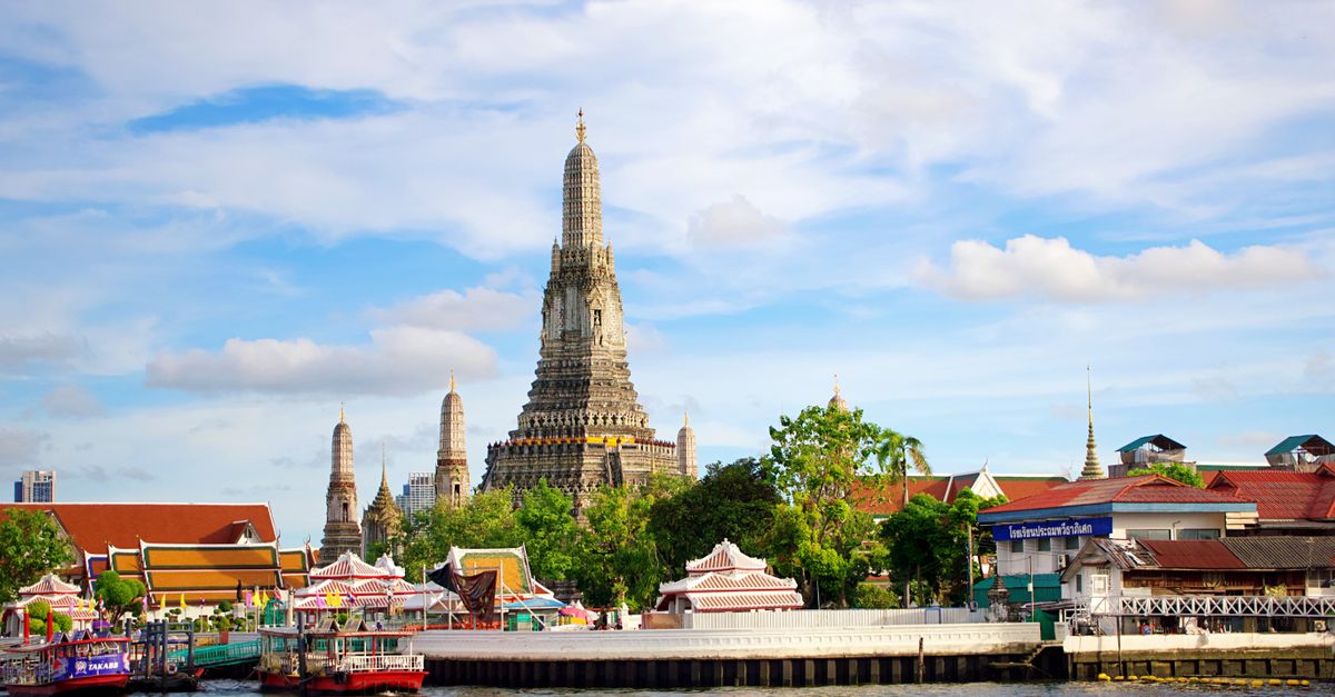 Beautiful view of Wat Arun Temple across the Chao Phraya River in Bangkok, Thailand.