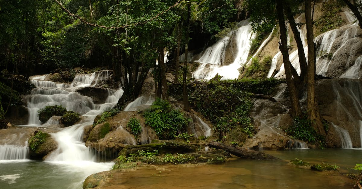 Serene waterfall amidst lush greenery in Kanchanaburi, Thailand, perfect for nature lovers.
