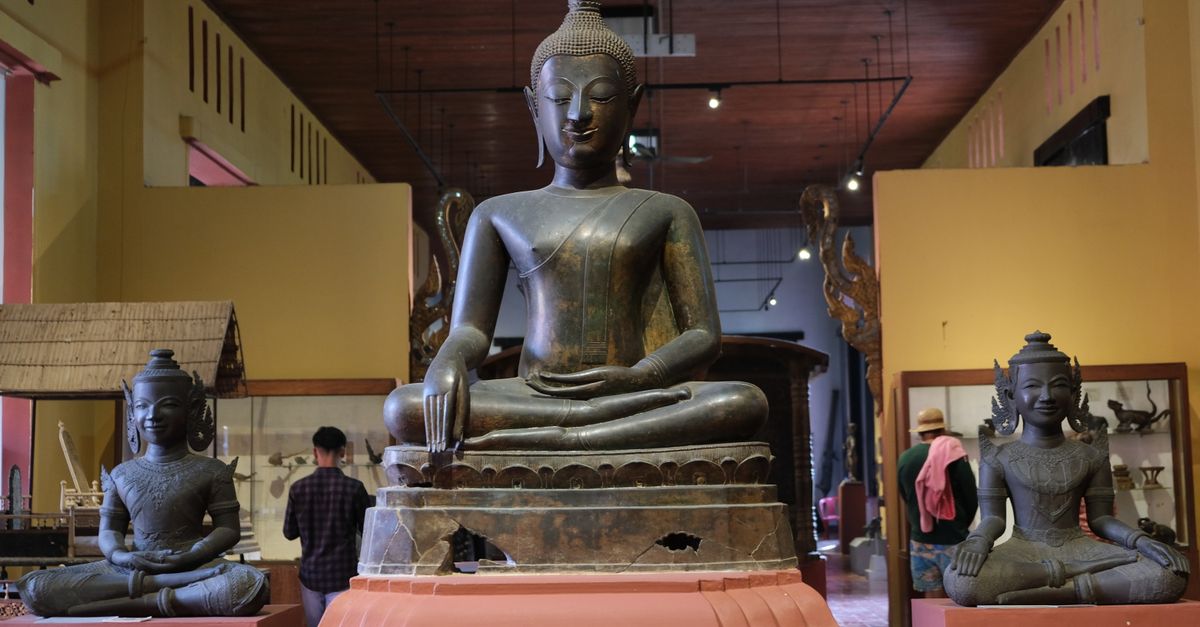 Serene Buddha statues on display in a Cambodian museum interior.