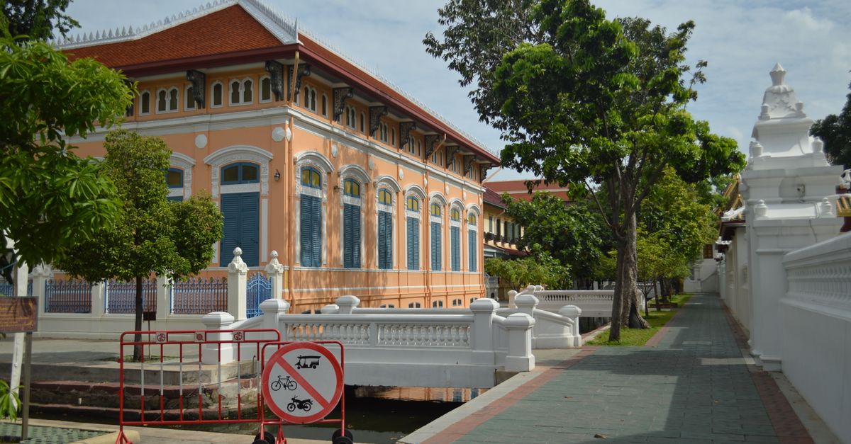 Historic building with a no bicycle sign in a sunny outdoor setting.