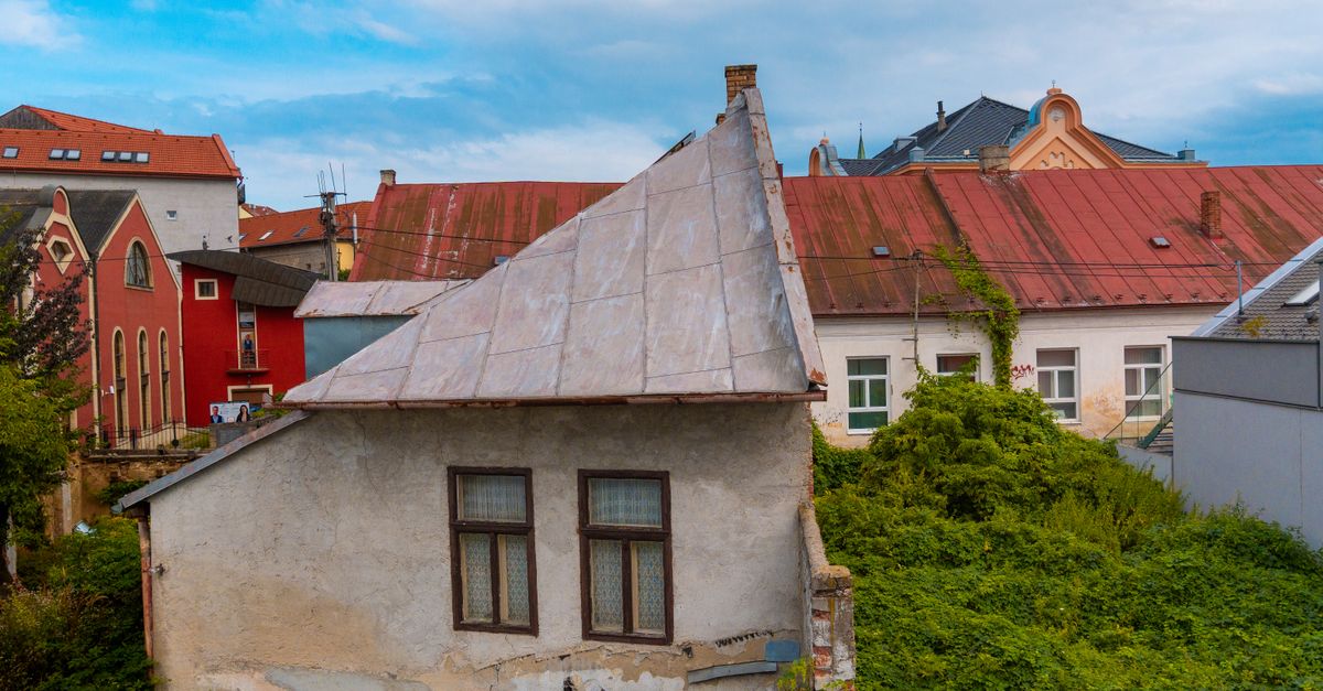 A picturesque view of colorful European rooftops and greenery in a quaint neighborhood.