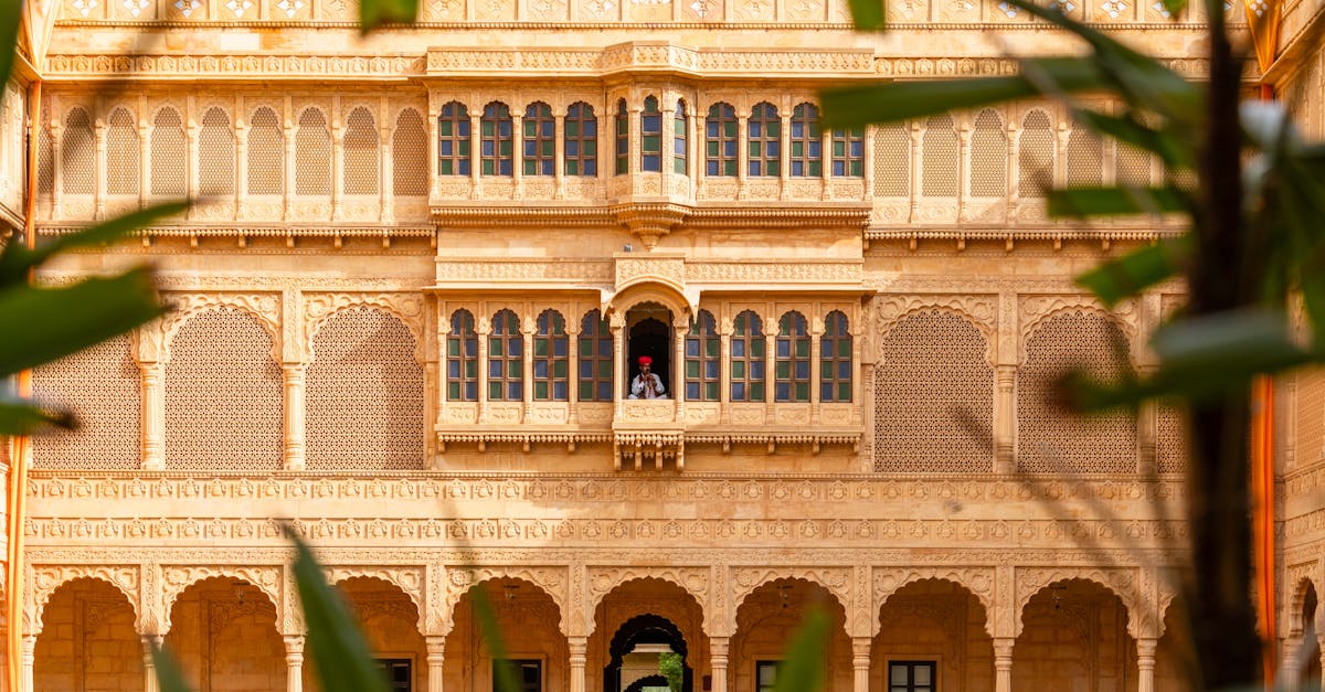 Stunning view of ornate Rajasthani architecture with a folk musician in Jaisalmer, India.