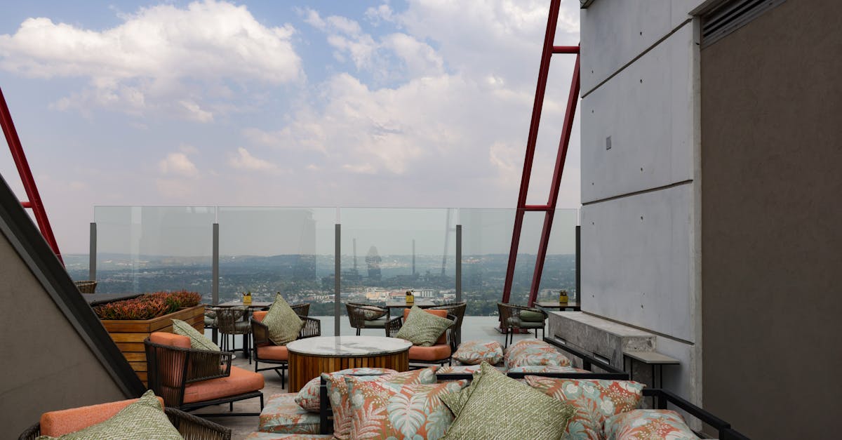 Stylish rooftop seating area offering a panoramic cityscape view with modern decor.