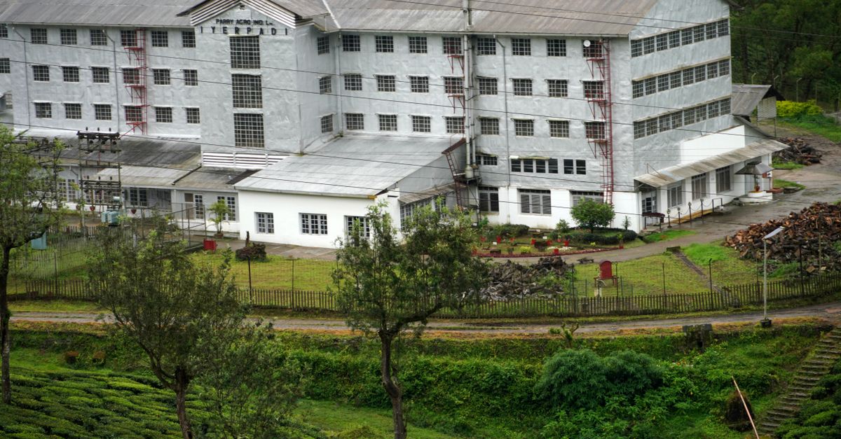 A scenic view of a tea factory amidst lush greenery in Valparai, Tamil Nadu, India.