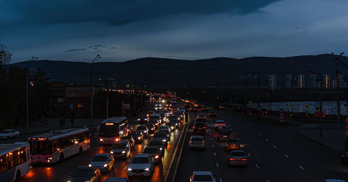 A vibrant scene of night traffic on a city highway, showcasing bustling urban life.