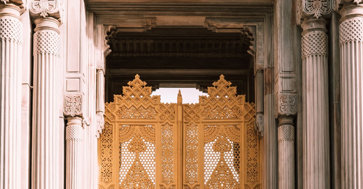 Intricate golden gate and detailed columns showcase classic architectural style.
