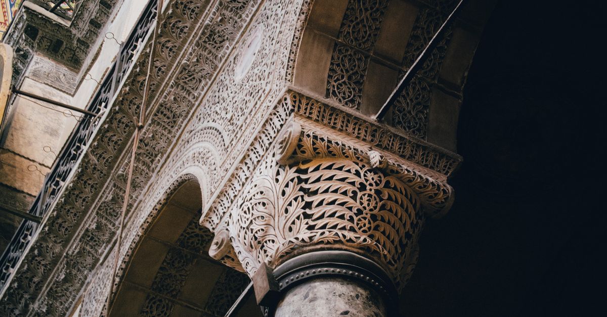 Close-up view of an intricately carved stone arch, showcasing detailed patterns and craftsmanship.