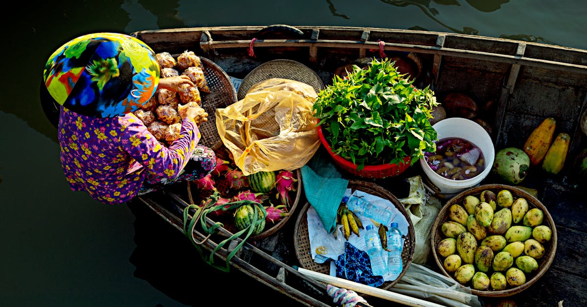 A vibrant view of a vendor in a traditional floating market selling fresh fruits and vegetables from a boat.