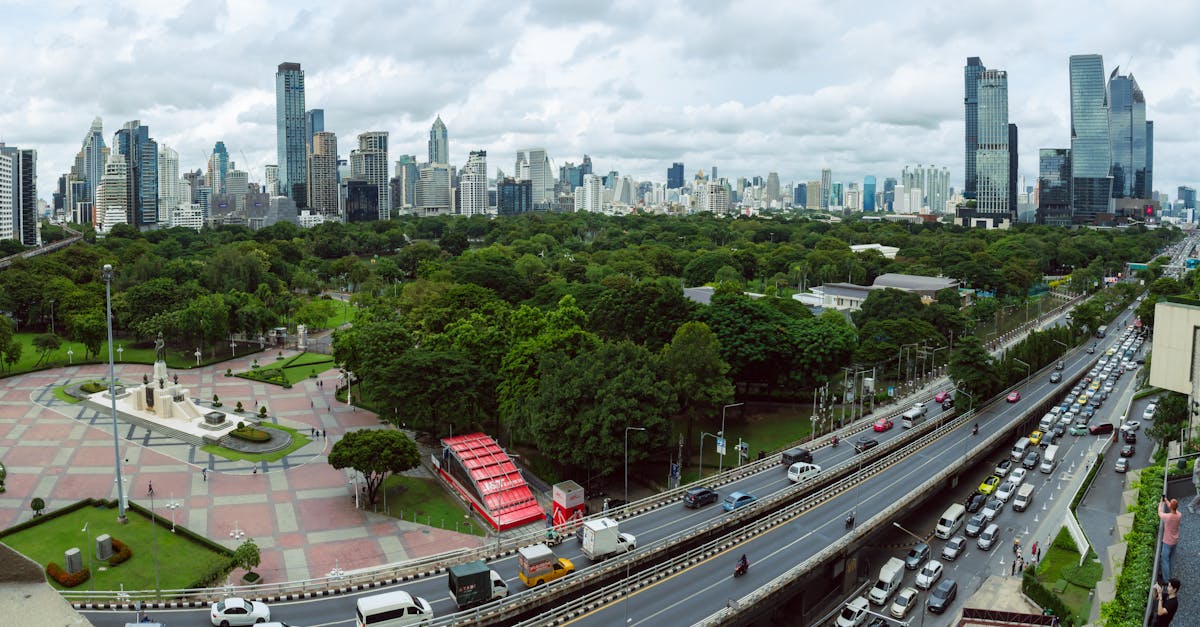 Stunning aerial view of Bangkok's skyline and Lumphini Park showcasing urban life and green space.