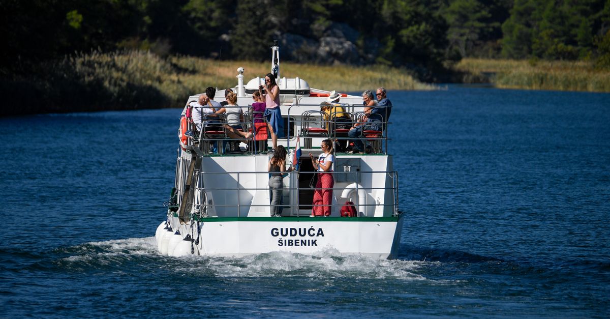 Tourists enjoy a scenic boat ride on a sunny day in Šibenik, Croatia.