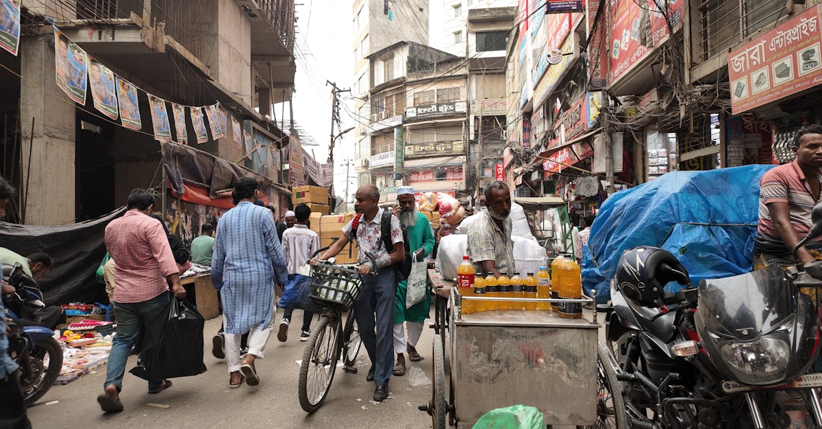 Lively street scene in Dhaka, showcasing vendors, shoppers, and local architecture.