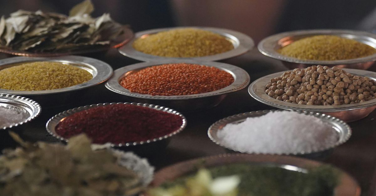 Close-up of assorted spices and grains in metal bowls showcasing culinary variety.