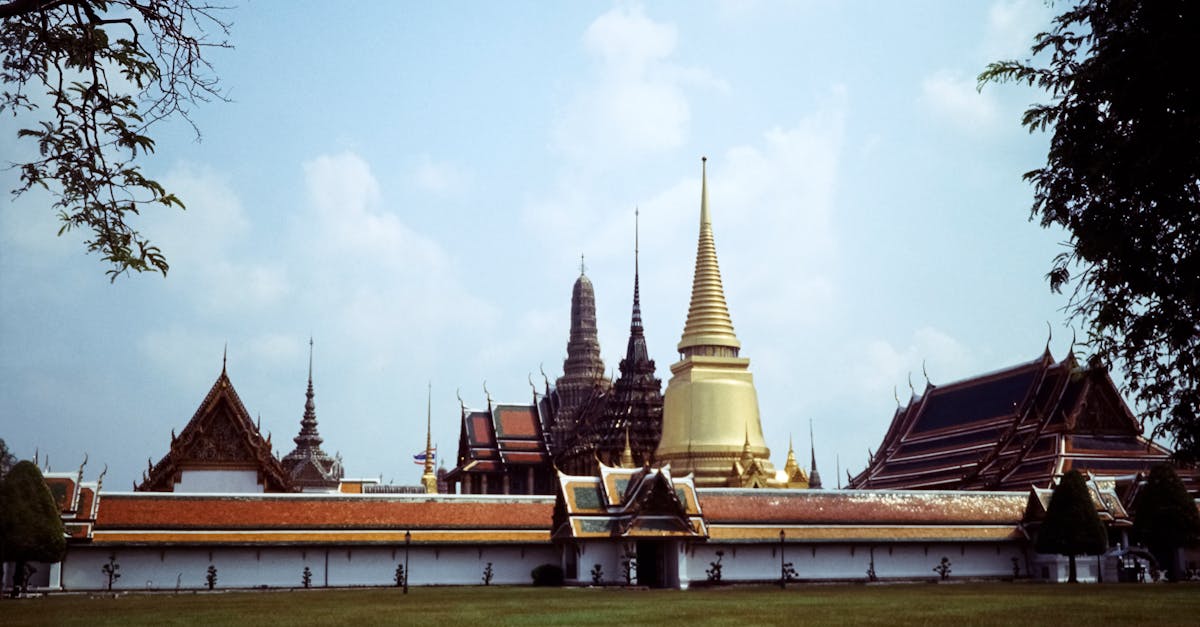 Panoramic view of the Grand Palace in Bangkok featuring a stunning golden pagoda.